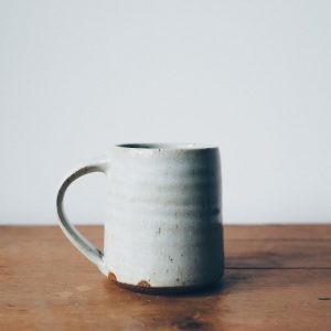 A handmade, wheel-thrown mug dipped in gray glaze.