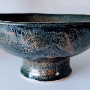 Wide, blue glaze with swirls of orange plate with a stand