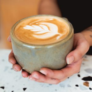 A handmade, wheel-thrown large mug with no handle.